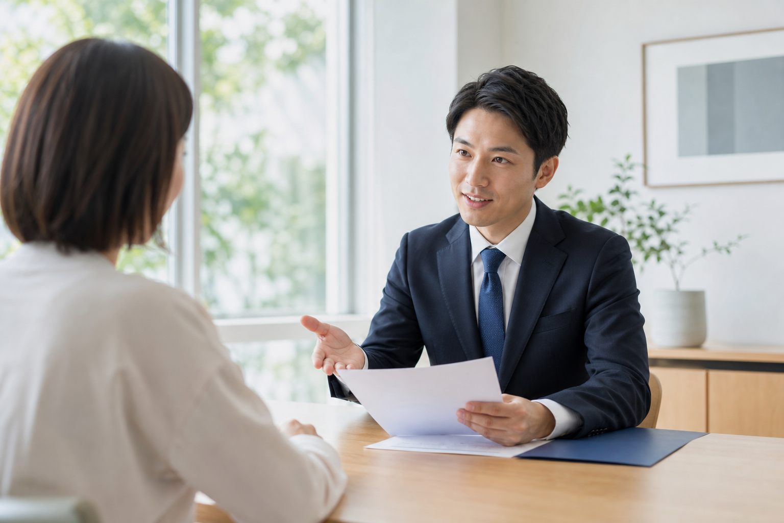 明るい相談室でタブレットを使いながら説明する司法書士